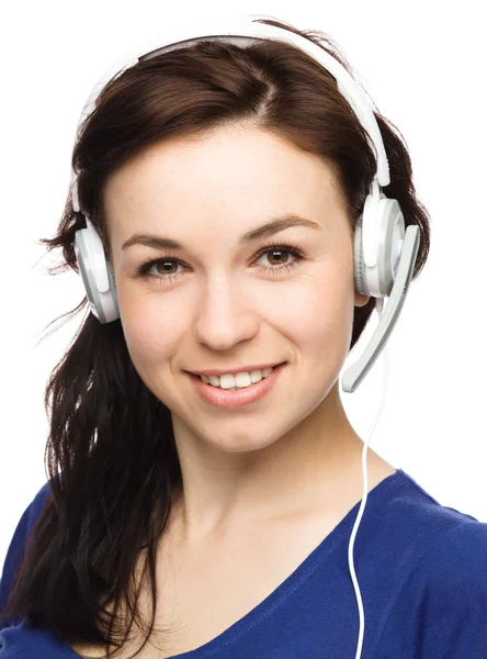 Lovely young woman is talking to customers — Stock Photo, Image