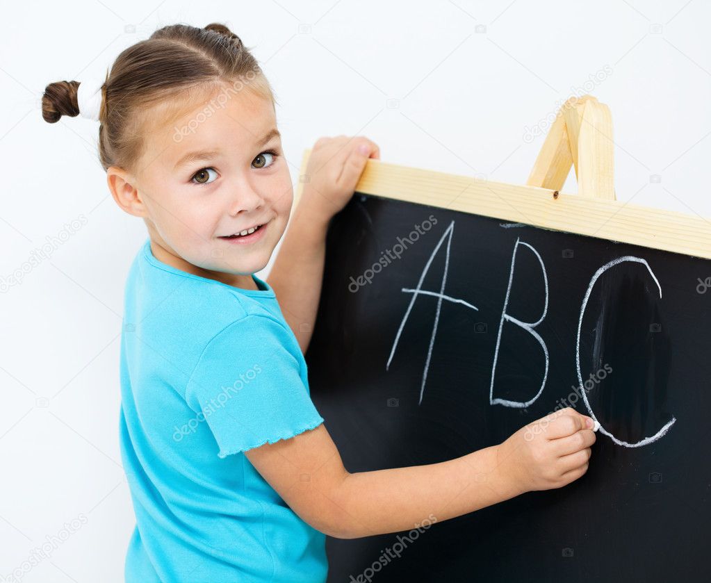 Little girl is showing letter E on the alphabet