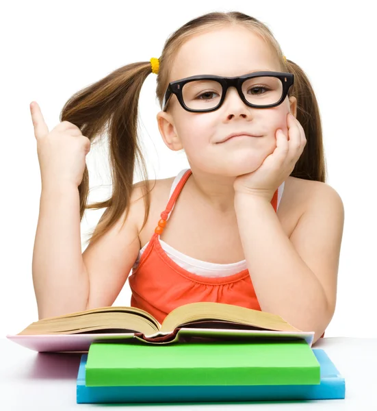 Cute cheerful little girl reading book — Stock Photo, Image