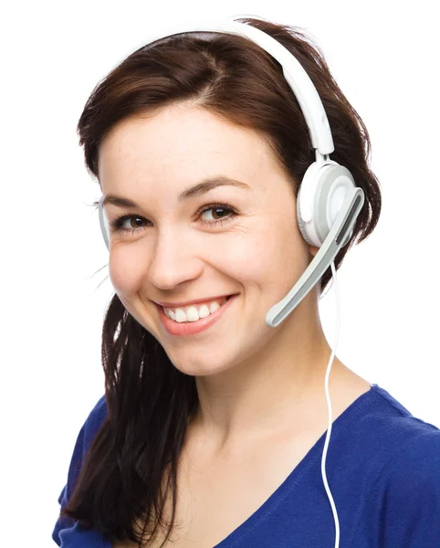 Lovely young woman is talking to customers — Stock Photo, Image
