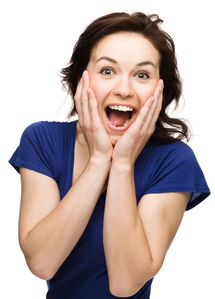 Woman is holding her face in astonishment Stock Picture