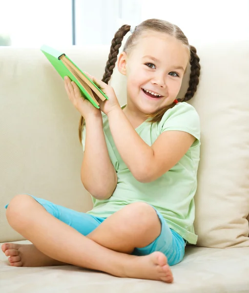 Little girl reads a book Stock Picture