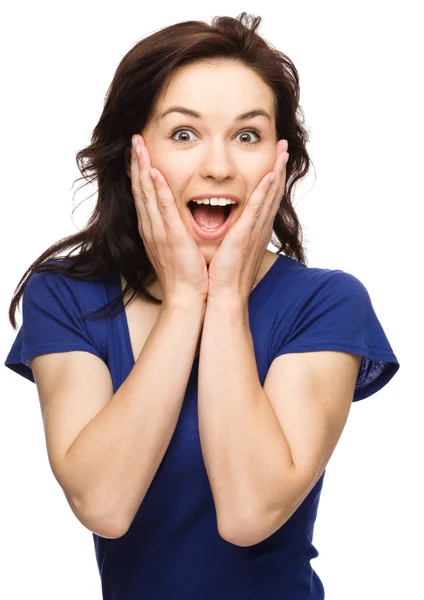 Woman is holding her face in astonishment — Stock Photo, Image