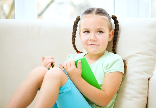 Liten flicka läser en bok — Stockfoto