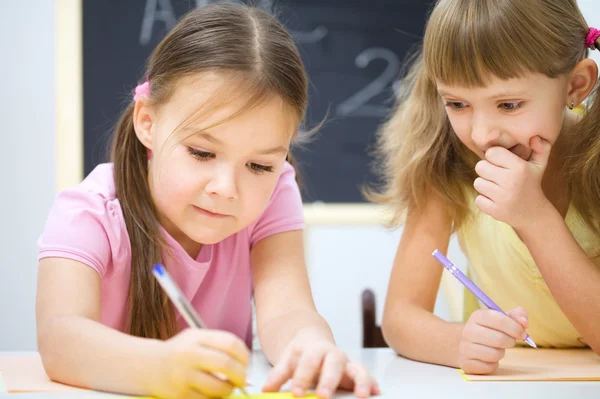 Las niñas están escribiendo usando un bolígrafo —  Fotos de Stock