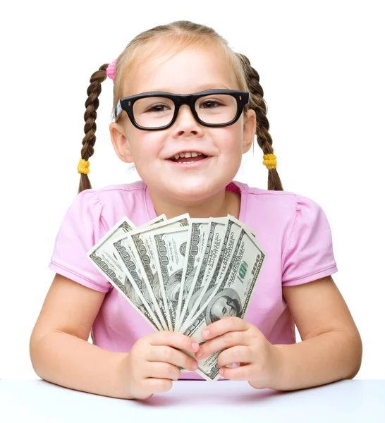 Little girl is counting dollars — Stock Photo, Image