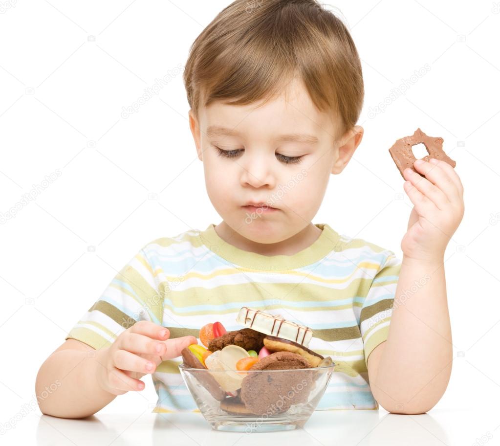 Portrait of a boy with candies