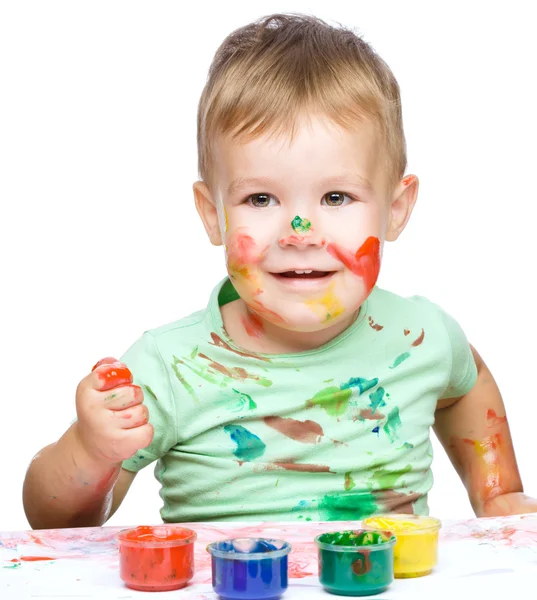 Menino está brincando com tintas — Fotografia de Stock