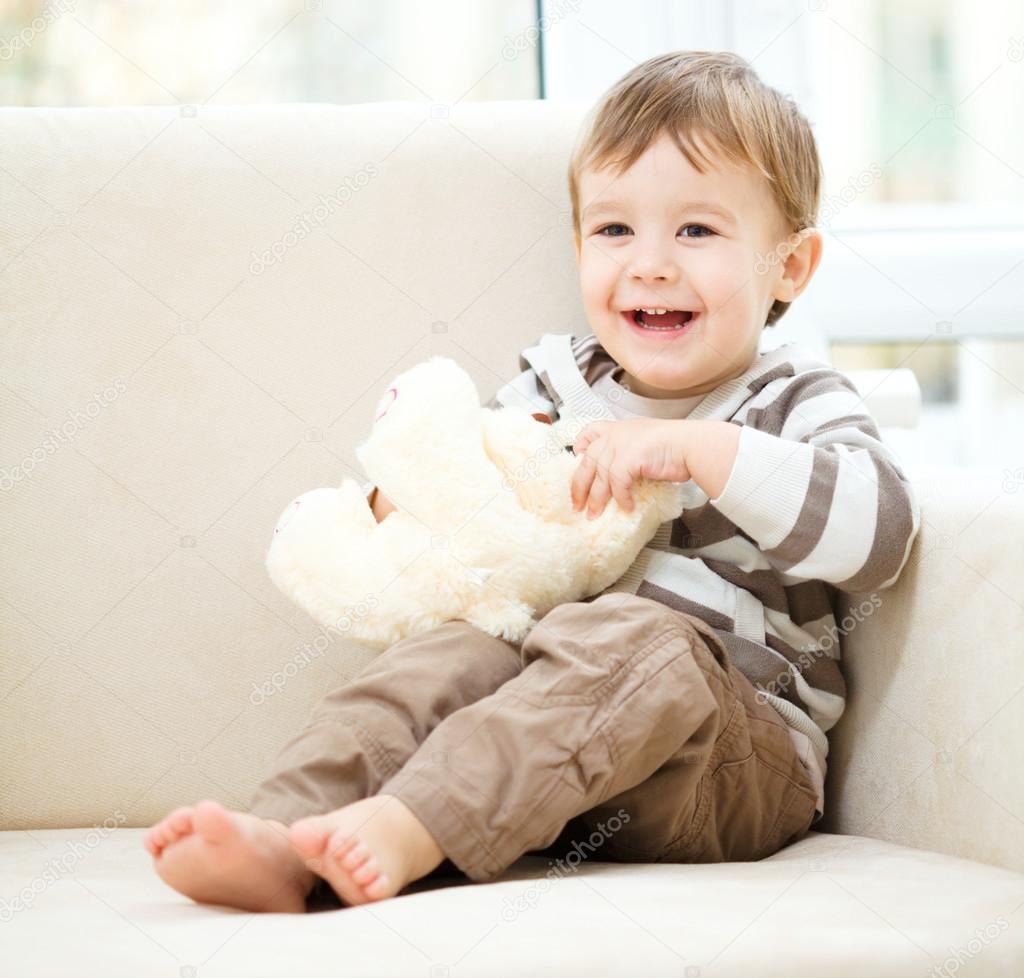 Portrait of a little boy with his teddy bear