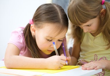 Little girls are writing using a pen clipart