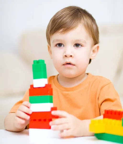 Chico está jugando con bloques de construcción —  Fotos de Stock