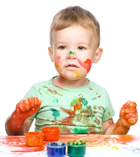 Little boy is playing with paints Royalty Free Stock Photos