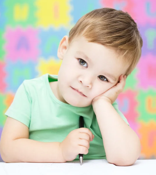 Little boy is writing on his copybook — Stock Photo, Image