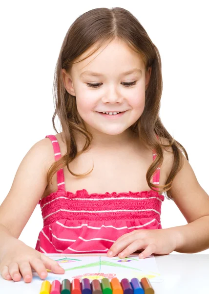 Little girl is drawing using colorful crayons — Stock Photo, Image