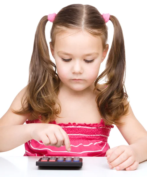 Little girl is using calculator — Stock Photo, Image