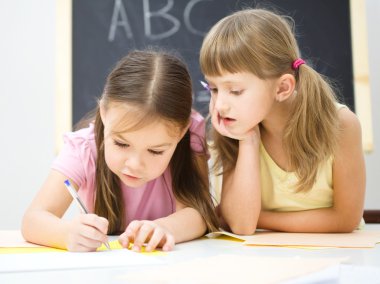 Little girls are writing using a pen clipart