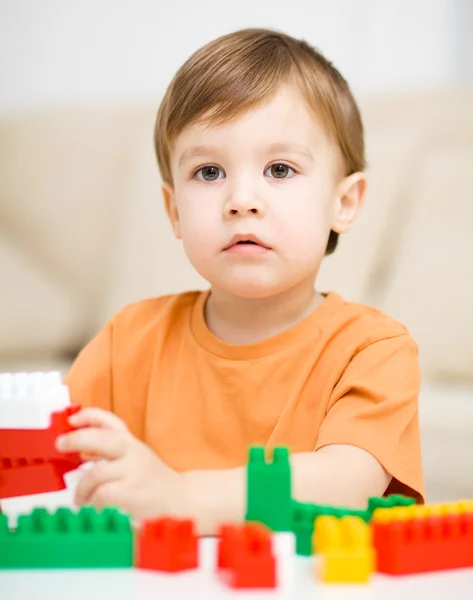 Chico está jugando con bloques de construcción — Foto de Stock