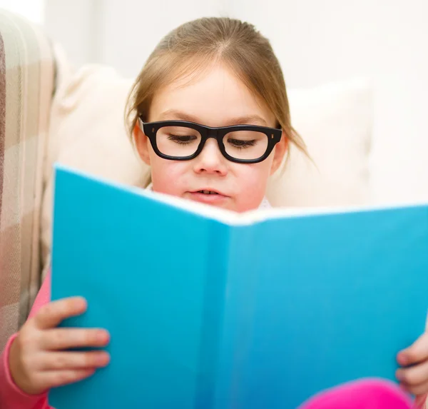 Liten flicka läser en bok — Stockfoto