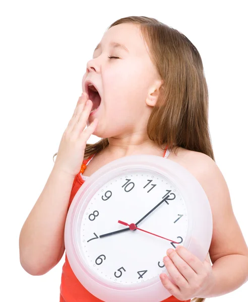 Little girl is holding big clock — Stock Photo, Image