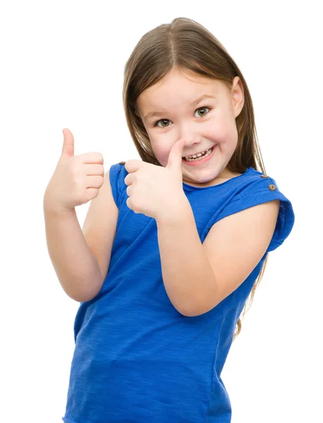 Malá holčička se ukazuje palcem nahoru gesto — Stock fotografie
