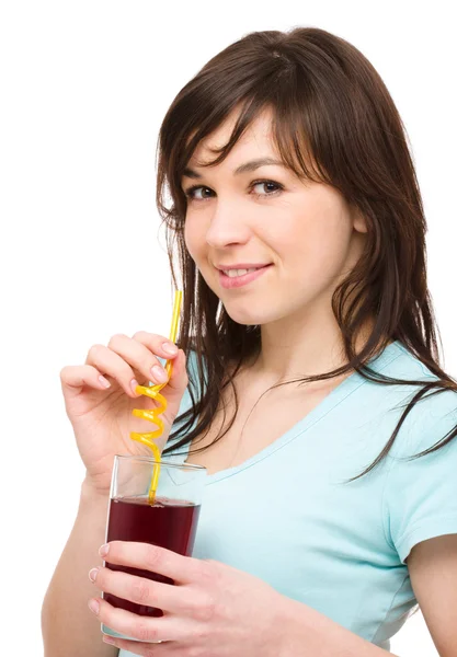 Young woman is drinking cherry juice — Stock Photo, Image