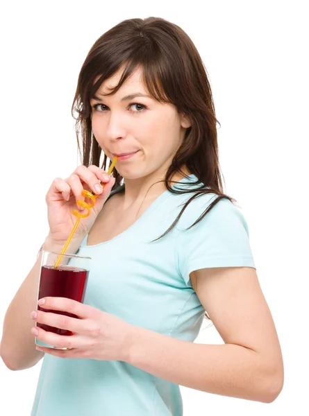 Young woman is drinking cherry juice — Stock Photo, Image