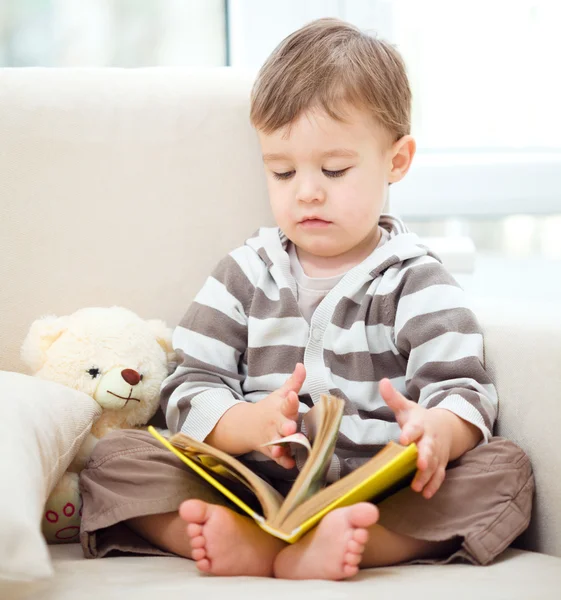 Little boy is reading book — Stock Photo, Image