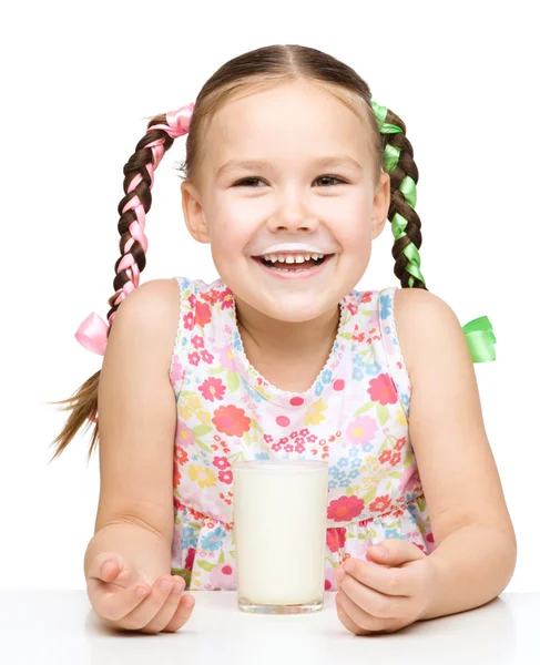 Cute little girl showing milk moustache — Stock Photo, Image