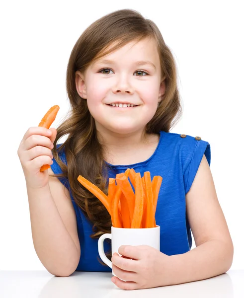 Roztomilá holčička je jíst mrkev — Stock fotografie