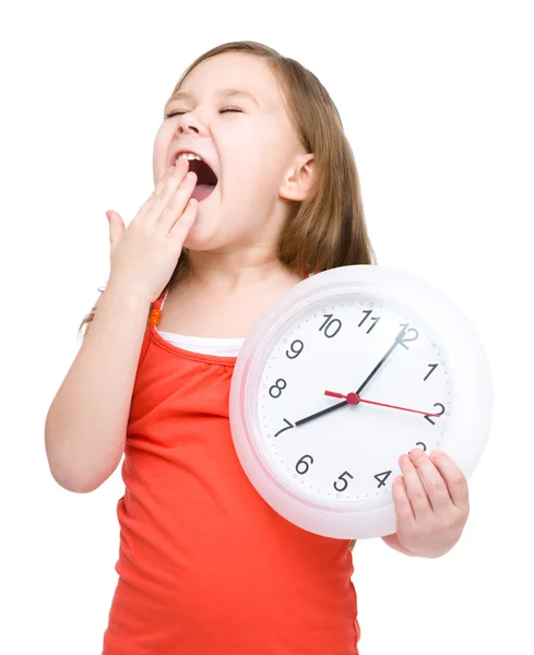 Little girl is holding big clock — Stock Photo, Image