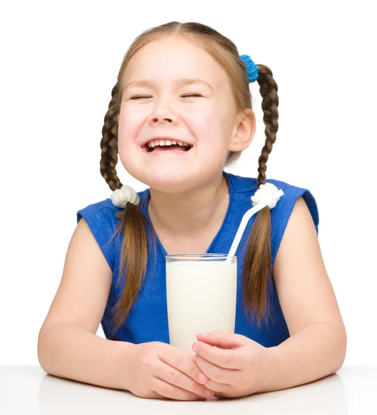 Sad little girl with a glass of milk — Stock Photo, Image