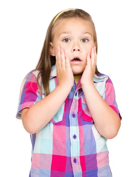 Little girl is holding her face in astonishment — Stock Photo, Image