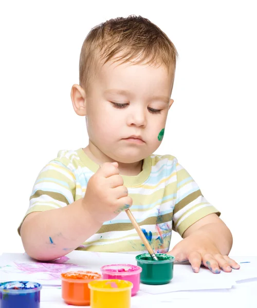 Little boy is playing with paints — Stock Photo, Image