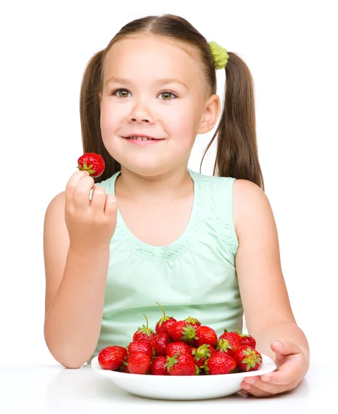 Little girl is eating strawberries — Stock Photo, Image