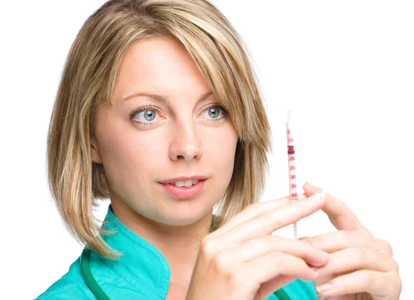 Young nurse is preparing syringe for injection — Stock Photo, Image