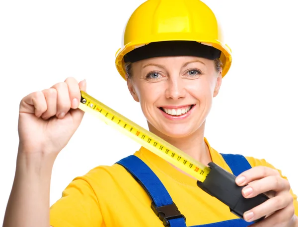 Young construction worker with tape measure — Stock Photo, Image