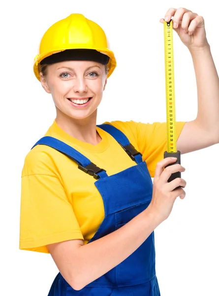 Young construction worker with tape measure — Stock Photo, Image