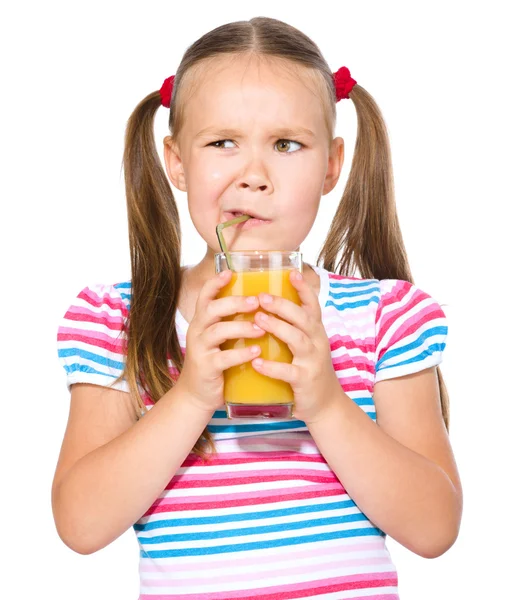 Little girl unwillingly drinking orange juice — Stock Photo, Image