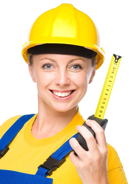 Young construction worker with tape measure — Stock Photo, Image