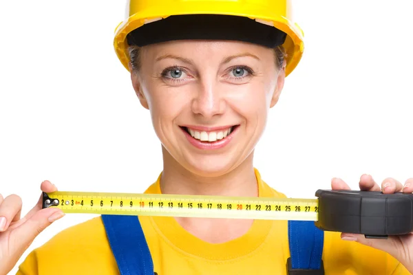 Young construction worker with tape measure — Stock Photo, Image