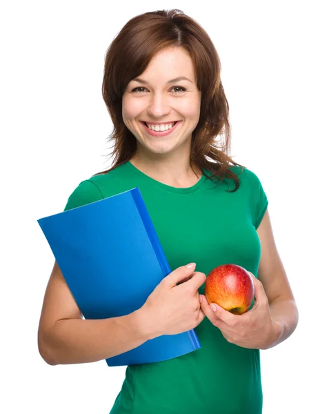 Mladý student dívka drží knihu a apple — Stock fotografie