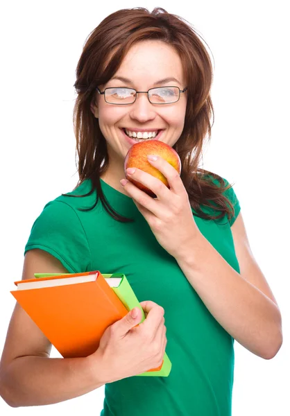 Jeune fille étudiante tient livre et pomme — Photo