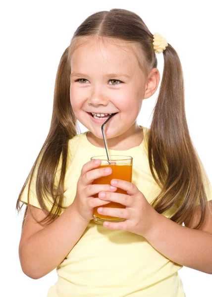 Little girl is drinking carrot juice — Stock Photo, Image