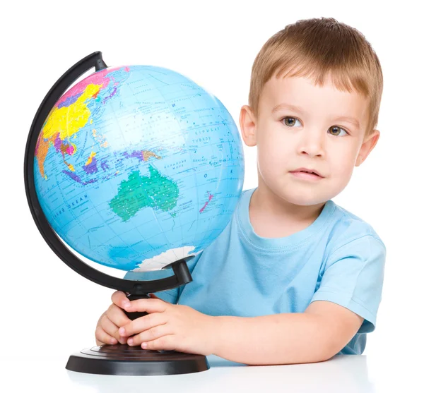 Happy little boy with a globe — Stock Photo, Image