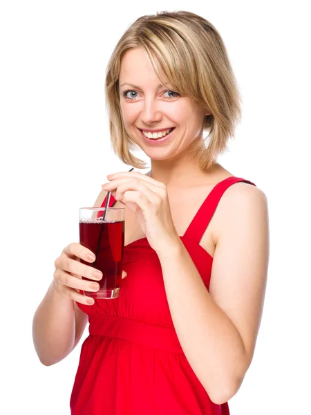 Young woman is drinking cherry juice — Stock Photo, Image