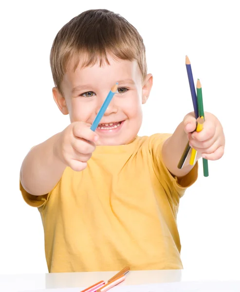Little boy is playing with color pencils — Stock Photo, Image