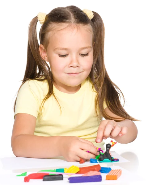 Little girl is playing with plasticine — Stock Photo, Image