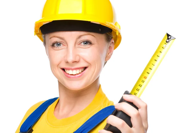 Young construction worker with tape measure — Stock Photo, Image