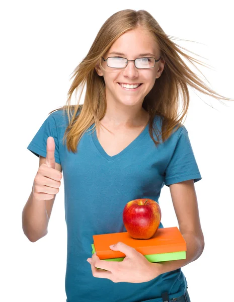 Молодая студентка держит в руках книгу и яблоко — стоковое фото