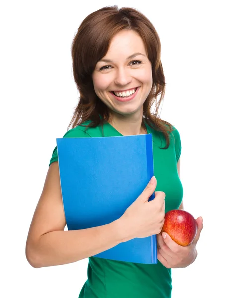 Giovane studentessa è in possesso di libro e mela — Foto Stock